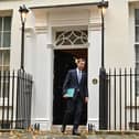 Britain's Chancellor of the Exchequer Jeremy Hunt walks out of Number 11 Downing Street 