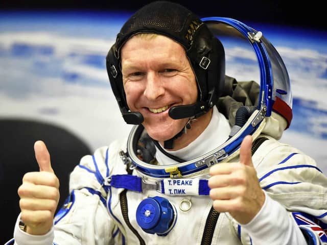 Britain's astronaut Tim Peake gestures as his space suit is tested at the Russian-leased Baikonur cosmodrome (photo: Getty Images)