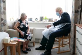Prime Minister Boris Johnson talks to resident Kathleen during a visit to Westport Care Home in east London on September 7, 2021. - Breaking an election pledge not to raise taxes, British Prime Minister Boris Johnson today announced hefty new funding to fix a social care crisis and a pandemic surge in hospital waiting lists. (Photo by Paul EDWARDS / POOL / AFP) (Photo by PAUL EDWARDS/POOL/AFP via Getty Images)