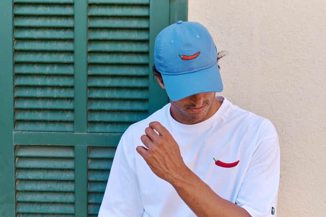 Some pieces feature direct embroidery and woven details incorporating a red chilli pepper - a nod to Sainz's famous "Chili" nickname