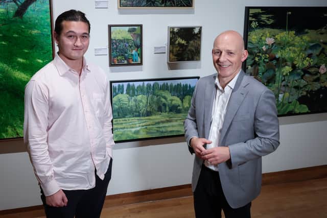 KPMG Young Artist Prize winner Pete Holland is pictured with Johnny Hanna, Partner in Charge of KPMG in Northern Ireland, in front of Holland’s winning work, 'Lagan Blossoms'.