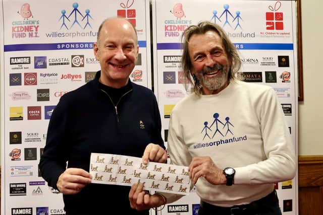 Willie Gregg presents a cheque to Stephen Watson from the NI Children's Kidney Fund. The presentation coincided with the seventh anniversary of Stephen's kidney transplant.