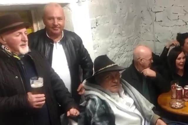 Terry Murphy (seated, wearing black hat) planned and attended his own wake. (Images/video courtesy of Justin McNulty)