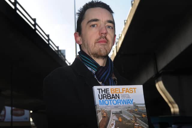 Wesley Johnston, who writes extensively about roads, at the M3 Flyover in Belfast city centr holding his book about the N Ireland  motorway system. 
Pic Colm Lenaghan/Pacemaker
