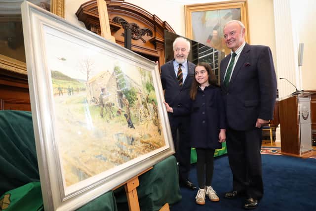 UDR veterans John Dunbar (left) and Jack Dunlop (also Trustee of the UDR Benevolent Fund) with their granddaughter Anna Dunbar at the unveiling of the Terence Cuneo painting The Search in Belfast.