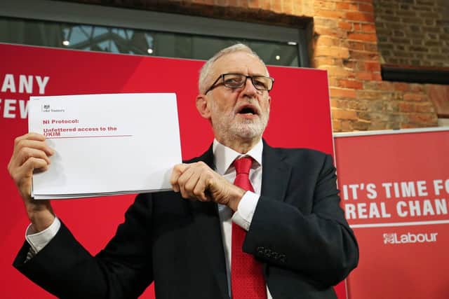 Labour Party leader Jeremy Corbyn holds up a leaked document relating to Northern Ireland, during a press conference in central London, whilst on the General Election campaign trail. (Photo: Jonathan Brady/PA Wire)