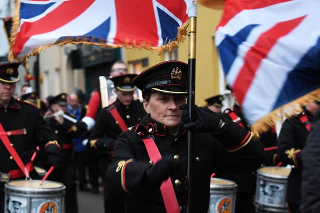 A flag bearer with the Cormeen Rising Sons of William Flute Band marching in Londonderry on Saturday. DER4919-113KM