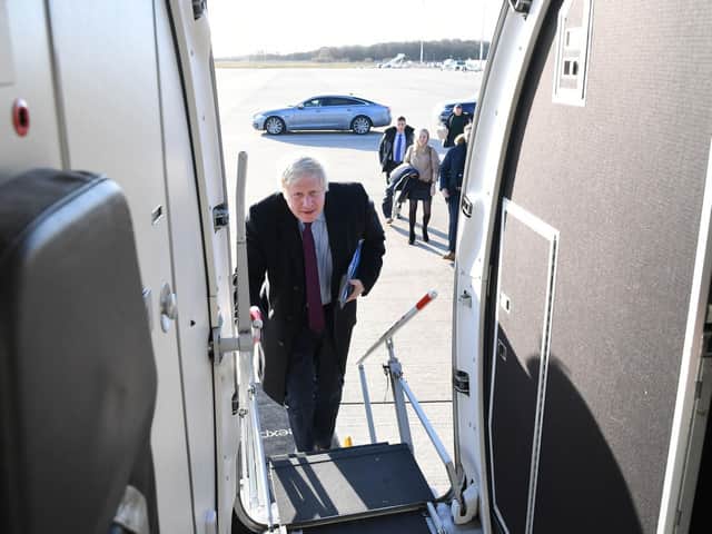 Prime Minister Boris Johnson boards his plane, following a visit to a Grimsby Fish Market, as he heads north to Teesside for the next stop on the General Election campaign trail