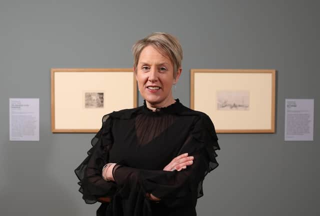 National Museums NI chief executive Kathryn Thomson with etchings by Rembrandt of The Adoration of the Shepherds (left) and  Six's Bridge, on display at the Ulster Museum