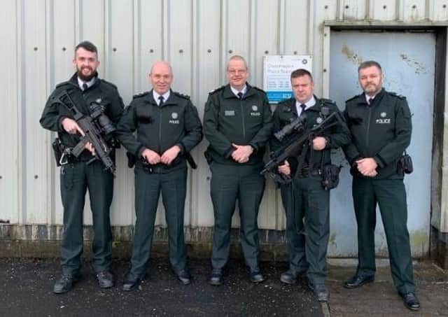 PSNI chief constable Simon Byrne (centre) with officers at Crossmaglen PSNI station