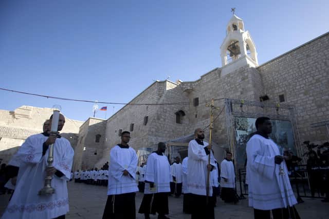 Clergymen outside the Church of the Nativity, built atop the site where Christians believe Jesus Christ was born, on Christmas Eve this year, in the West Bank City of Bethlehem.
Steven Jaffe writes: "When Israel relinquished control of Bethlehem to Yasser Arafat in 1995, 85% of the then prosperous town were Christians. By Christmas 2019, Christians are less than 10%"  (AP Photo/Majdi Mohammed)