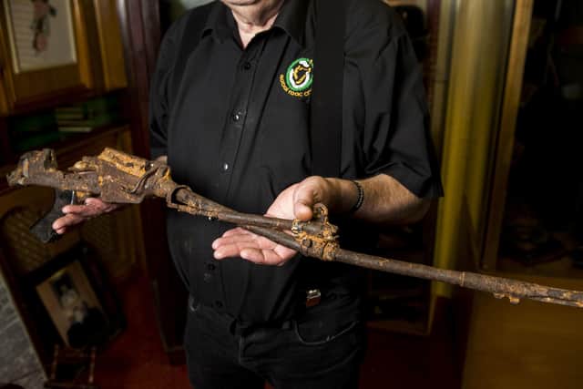 Kevin Carson, curator of  Roddy McCorley Society living history museum in west Belfast, holds a the mangled metal frame of an L1A1 Self-Loading Rifle. It was reportedly found on the Omeath foreshore approximately a year after the Narrow Water IRA attack that killed 18 soldiers in 1979. Photo: Liam McBurney/PA Wire