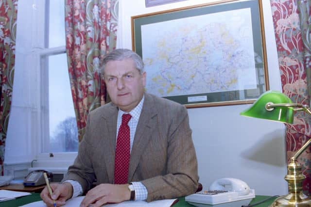 Sir Patrick Mayhew, Secretary of State, in his office.