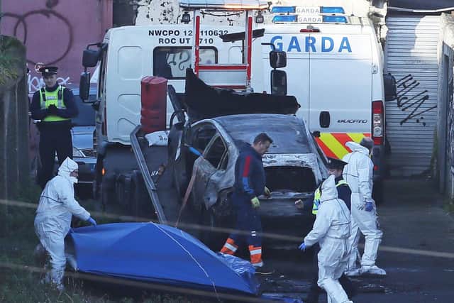 A burnt out car which contained human remains, believed to be linked to the disappearance of a 17-year-old boy from Co Louth, is removed from the scene on Trinity Terrace in the Drumcondra area of Dublin. (Photo: Brian Lawless/PA Wire)