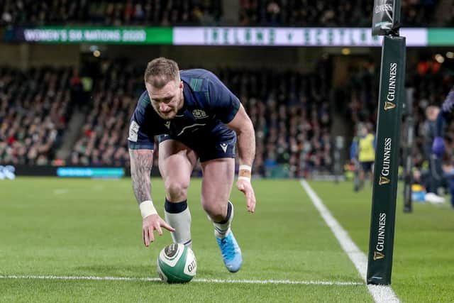 Scottish captain Stuart Hogg drops the ball as he goes over the try line against Ireland