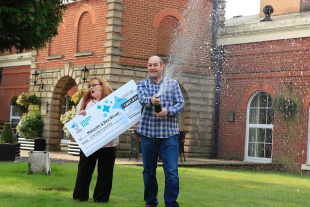 Malcolm and Bev Dixon, grandparents of 13 from Bolton, celebrating their one million pound lottery win