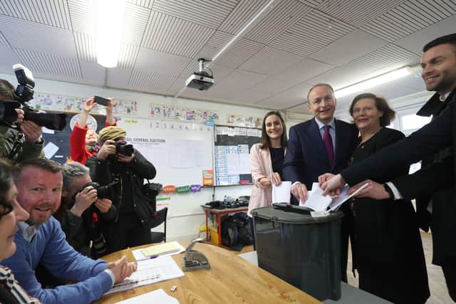 Fianna Fail leader Micheal Martin and family voting on Saturday in the Irish general election at St Anthony's Boys National School in Ballinlough, Cork. Photo: Yui Mok/PA Wire