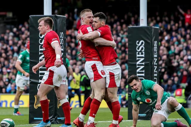 Wales celebrate scoring a try during the loss to Ireland