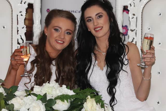 Robyn Peoples (left), 26, and Sharni Edwards, 27, at the Loughshore Hotel, in Carrickfergus, after they became the first couple to have a same-sex marriage in Northern Ireland.