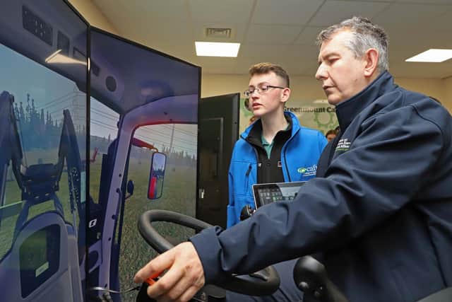 Agriculture Minister Edwin Poots MLA takes the wheel of one of CAFRE's new tractor driving simulators at Greenmount Campus watched by Level 3 Land-based Engineering student Christopher Robinson. The £100,000 investment in two simulators will allow students to learn in a safe environment and are the first to be used in an NI college. Photo Diarmuid McLaughlin