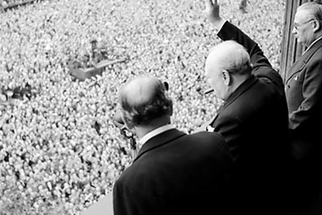 Churchill waves to crowds in Whitehall
