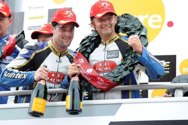 Dan Sayle (left) celebrates victory at the Isle of Man TT in 2011 with Klaus Klaffenbock.