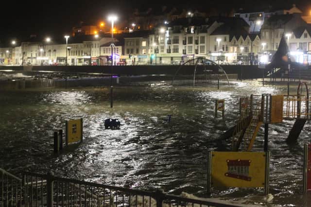 A flooded playground in Portstewart on the night of February 10, after Storm Ciara breached defensive sea walls; the Met Office has said the planet’s changing climate risks more extreme weather events – and that the UK is expected to have wetter winters