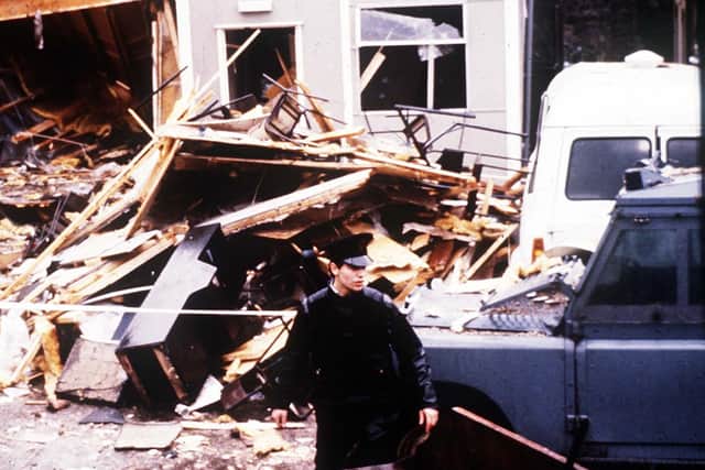An unknown RUC man stands amid the ruins of Newry polie station, after a multiple-mortar attack destroyed its cheap pre-fab-style canteen