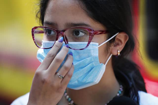 A teen wears a medical mask as a precaution against the spread of the new coronavirus