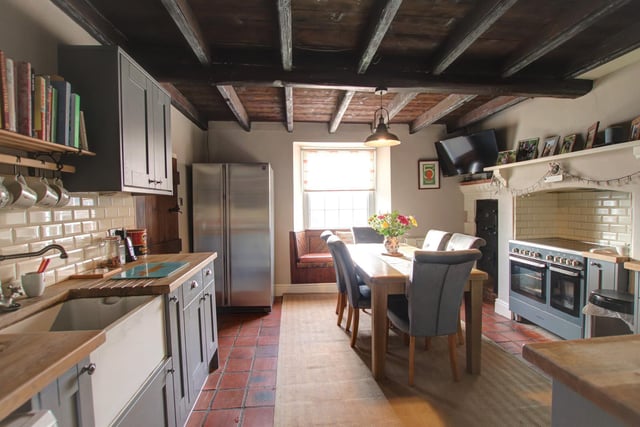 The warm and wwelcoming kitchen includes an antique bread oven feature.
