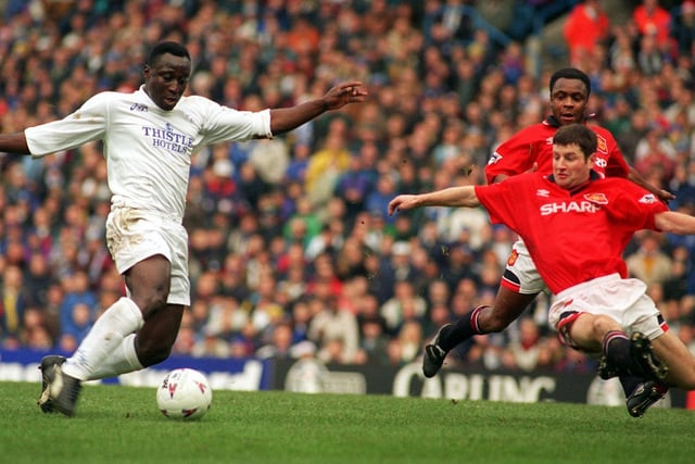 Tony Yeboah fires towards goal as Manchester United's Denis Irwin makes a desperate challenge.