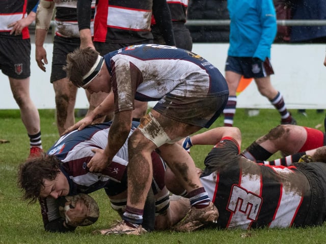 Scarborough RUFC's Luke Brown with ball, Ed Hopper rucking over.
