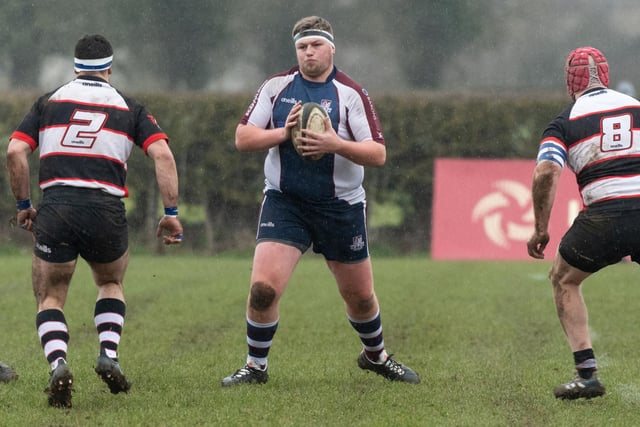 Scarborough RUFC's Tom Read is outnumbered by Malton & Norton RUFC players