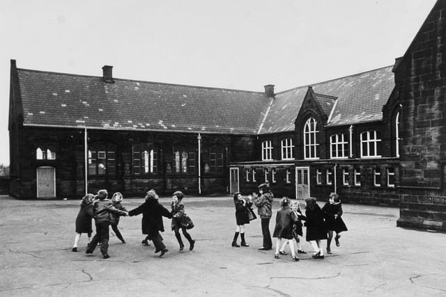 Fun in the playground at  Armley C. of E. School on Wesley Road in January 1974.