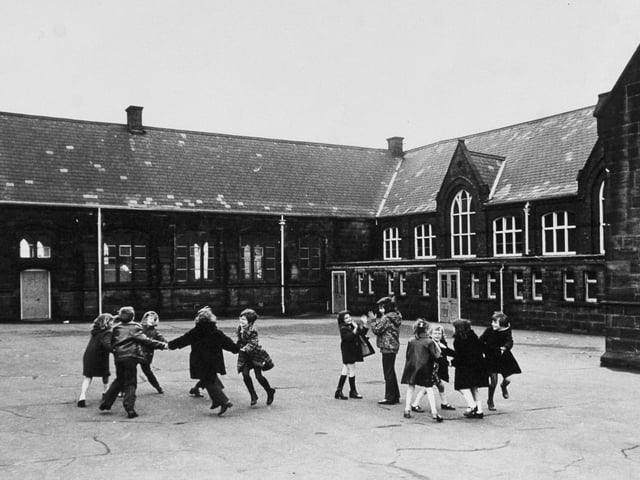 Fun in the playground at  Armley C. of E. School on Wesley Road in January 1974.