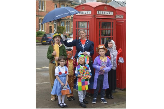 Pupils from St John's Priory School along with Headmistress Mrs Tracey Wilson dress up for World Book Day. Pictured outside the Banbury’s phone box library. (submitted photo from the school)