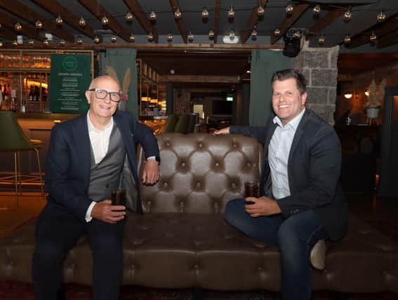 Hospitality Ulster chief executive Colin Neill (left) toasts the Executive’s one-metre distancing decision with Chris Brown in Belfast’s Margot Bar