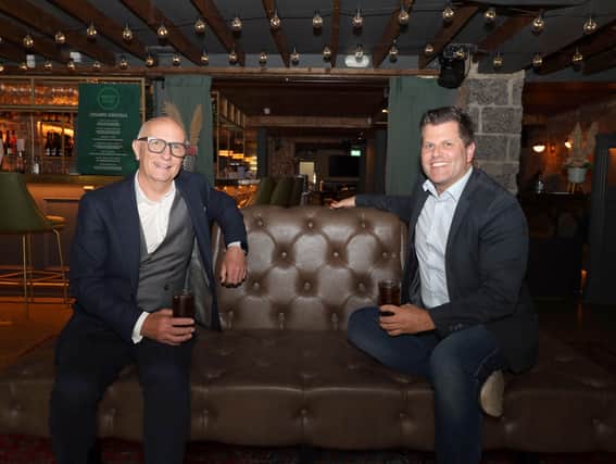 Colin Neill, Chief Executive of Hospitality Ulster, speaks to media today following the announcement of the relaxation of social distancing from 2m to 1m. He is pictured having a 1m socially distanced drink with Chris Brown in Margot Bar