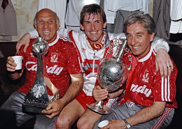 Liverpool player/manager Kenny Dalglish (centre), Ronnie Moran (left) and Roy Evans celebrate the 1989/90 Division One Championship. Pic by Getty.