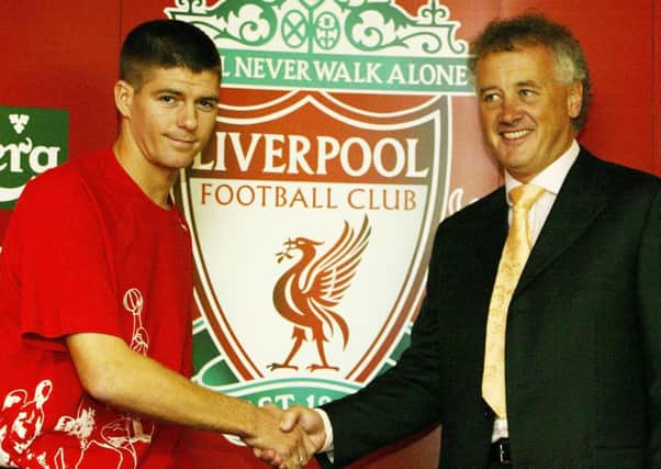 Liverpool's Steven Gerrard shakes hands with Liverpool chief executive Rick Parry in 2004 during a press conference at Anfield where he confirmed he was staying with Liverpool. Pic by PA.