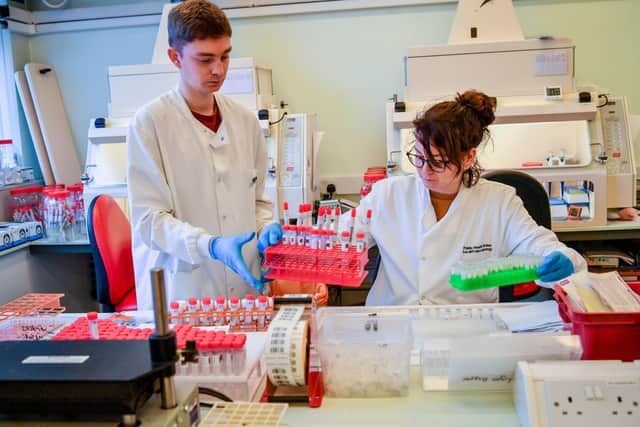 Lab technicians handle suspected COVID-19 samples