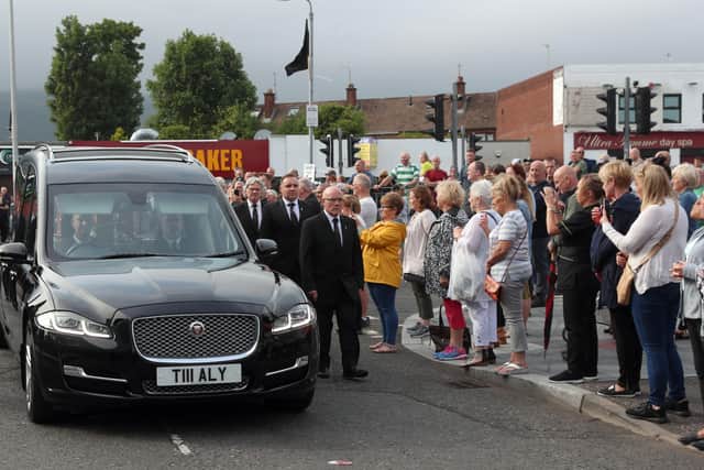 26/6/2020: A guard of honour flanks the hearse carrying the body of leading republican Bobby Storey to his Andersonstown home in Belfast