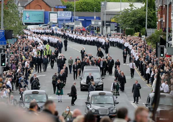 Large crowds line the funeral procession of the IRA leader Bobby Storey as it makes its way through west Belfast.  
Photo by Philip Magowan/Press Eye
