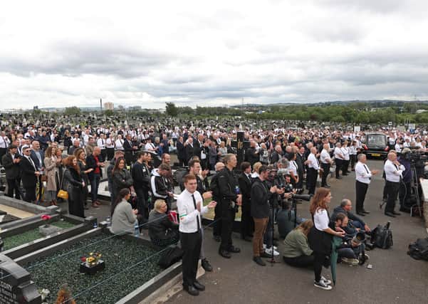 A crowd listens to former Sinn Fein president Gerry Adams speak during the funeral of senior Irish republican and former leading IRA figure Bobby Storey at Milltown Cemetery in west Belfast.