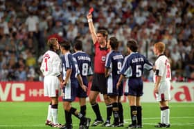England's David Beckham (L) is given the red card by Danish referee Kim Milton Nielsen, after a foul on Argentina's Diego Simeone during their France '98 World Cup second round match