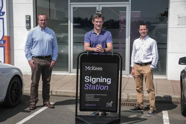 Chris Ross, Managing Partner of McKees and Donald Thompson, Partner, are pictured at the launch of the law firm’s new pop-up Signing Station on the Boucher Road in Belfast