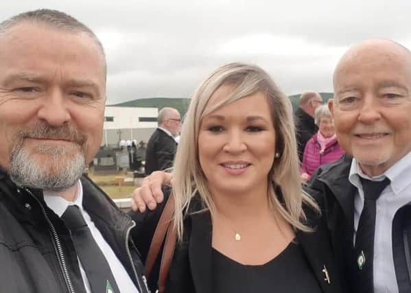 Michelle O'Neill posing for a selfie with two attendees at  Bobby Storey's funeral