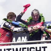 Joey Dunlop on the podium after his 26th and final Isle of Man TT victory in the 2000 Ultra-Lightweight race with his brother Robert (right) and runner-up, Denis McCullough.