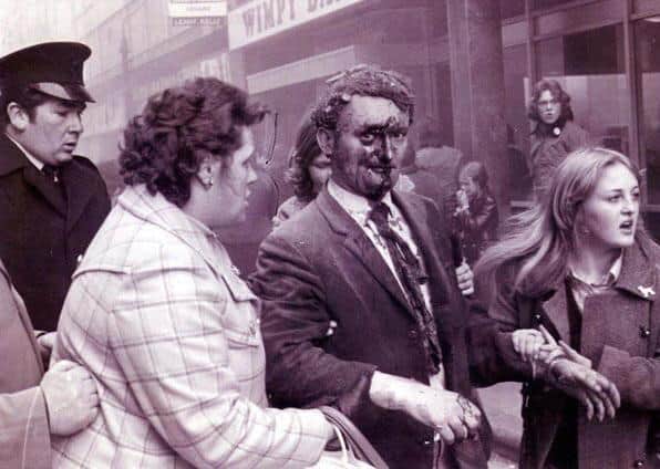 Thomas McFarlane (centre) pictured in the aftermath of the Abercorn bombing. Pic supplied by Ethan Campbell.
