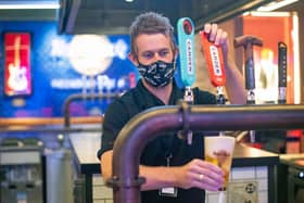 A barman wearing a face covering is just one new thing we will have to get used to as we prepare to visit pubs and restaurants all over Northern Ireland tomorrow. (Photo: PA Wire)